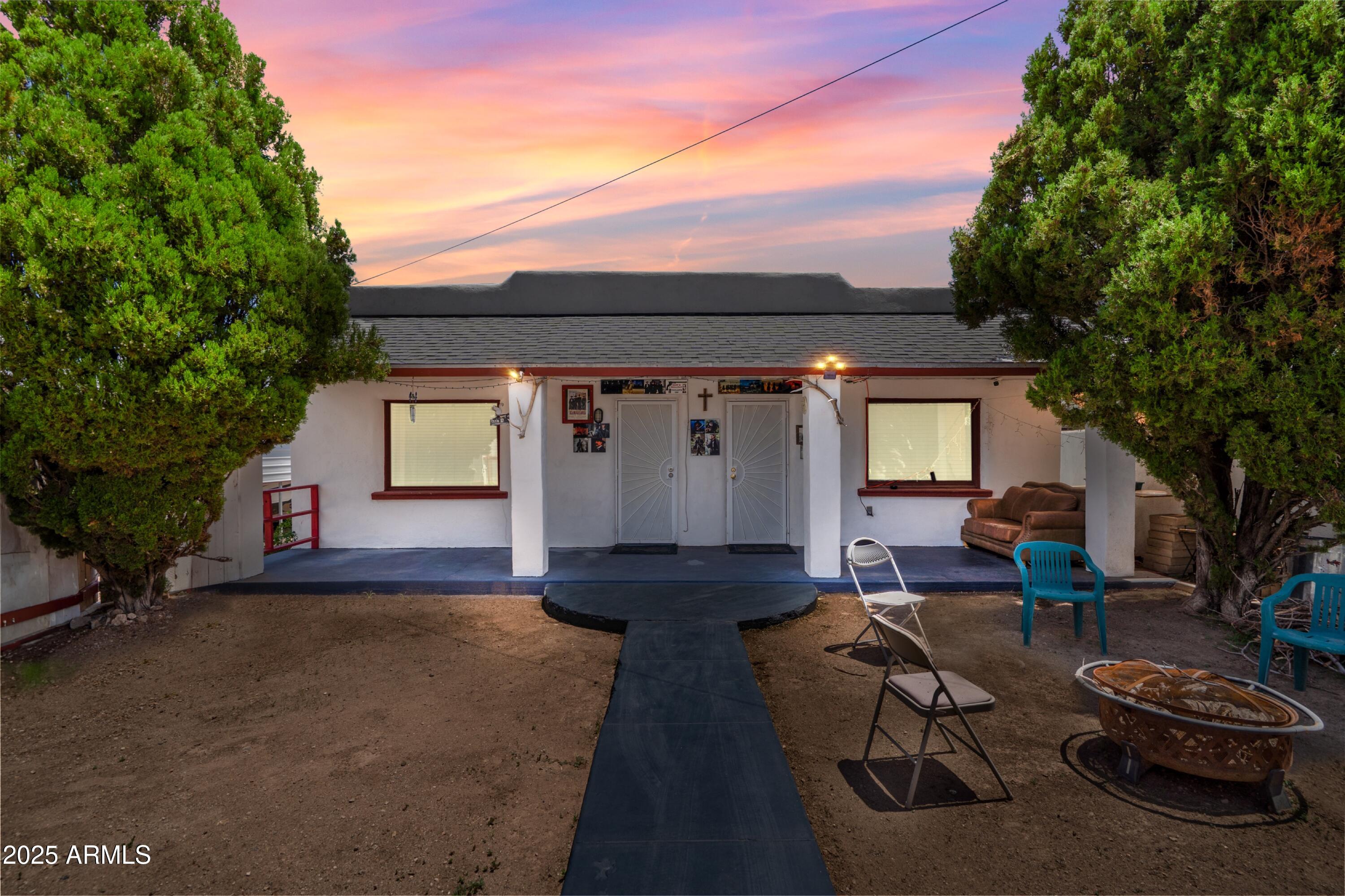 a view of a patio with couches table and chairs and potted plants