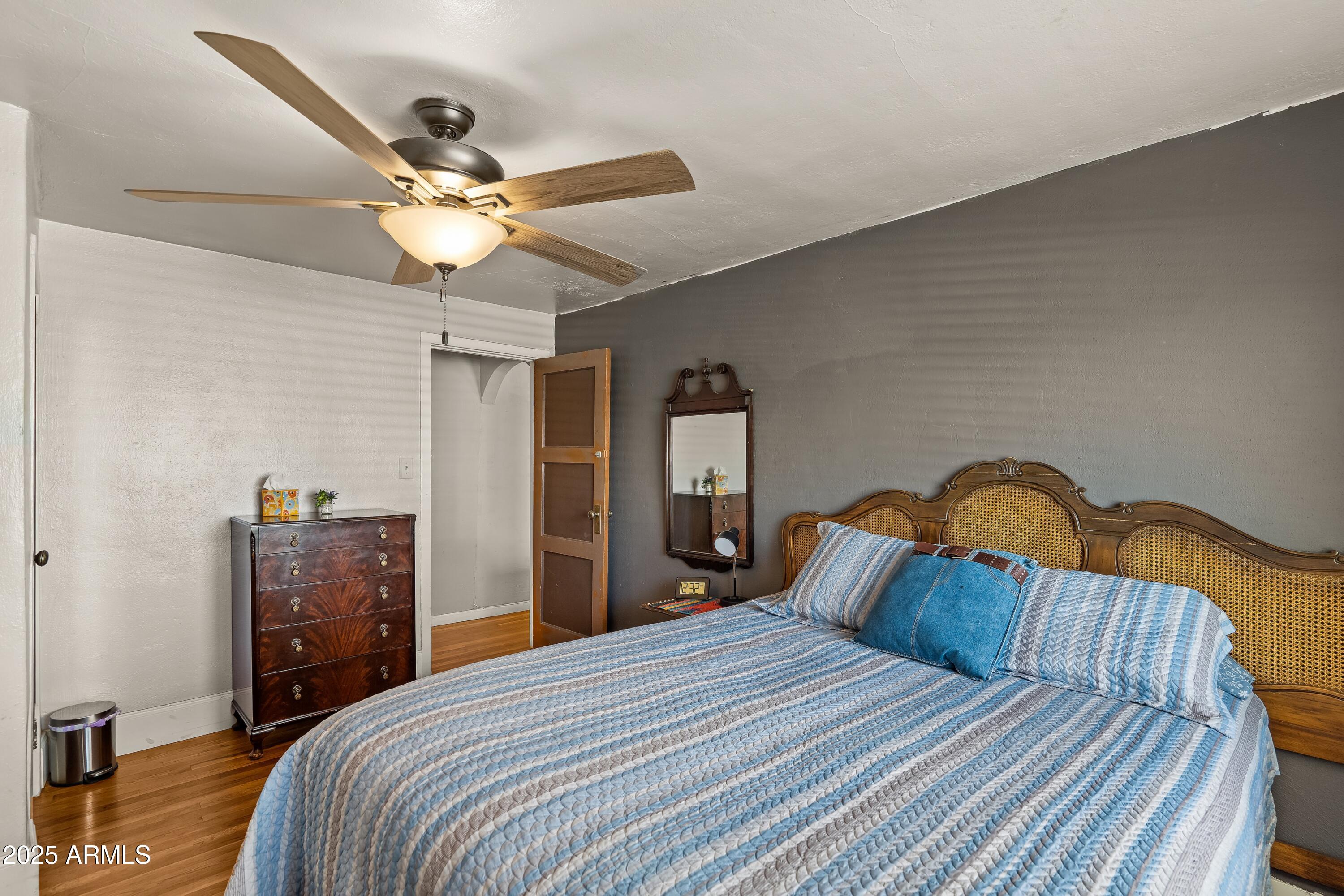 116 North 3rd Street Tombstone, AZ 85638 - Photo 11 of 64 a bedroom with a bed and a chandelier