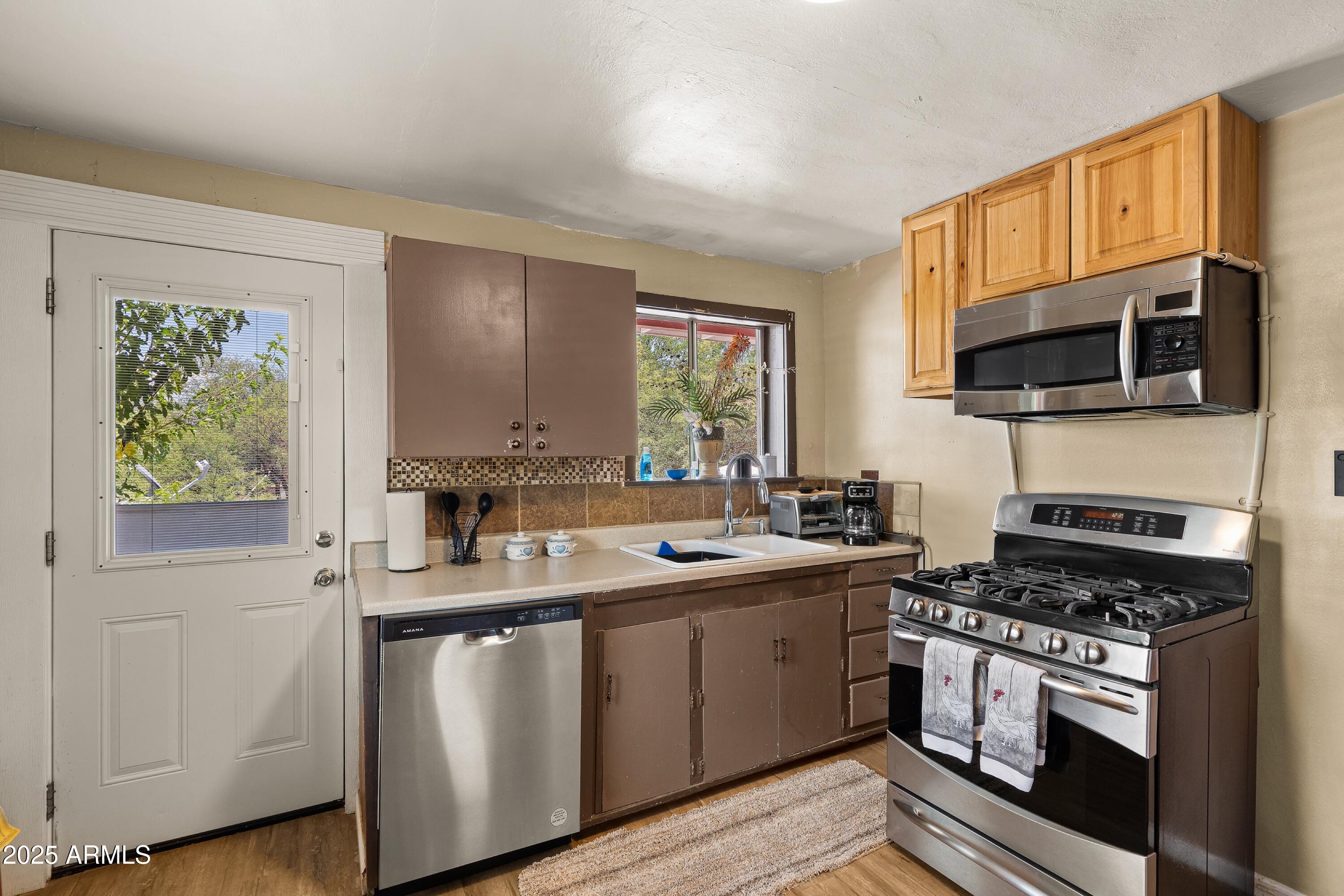 116 North 3rd Street Tombstone, AZ 85638 - Photo 13 of 64 a kitchen with a sink stove and microwave