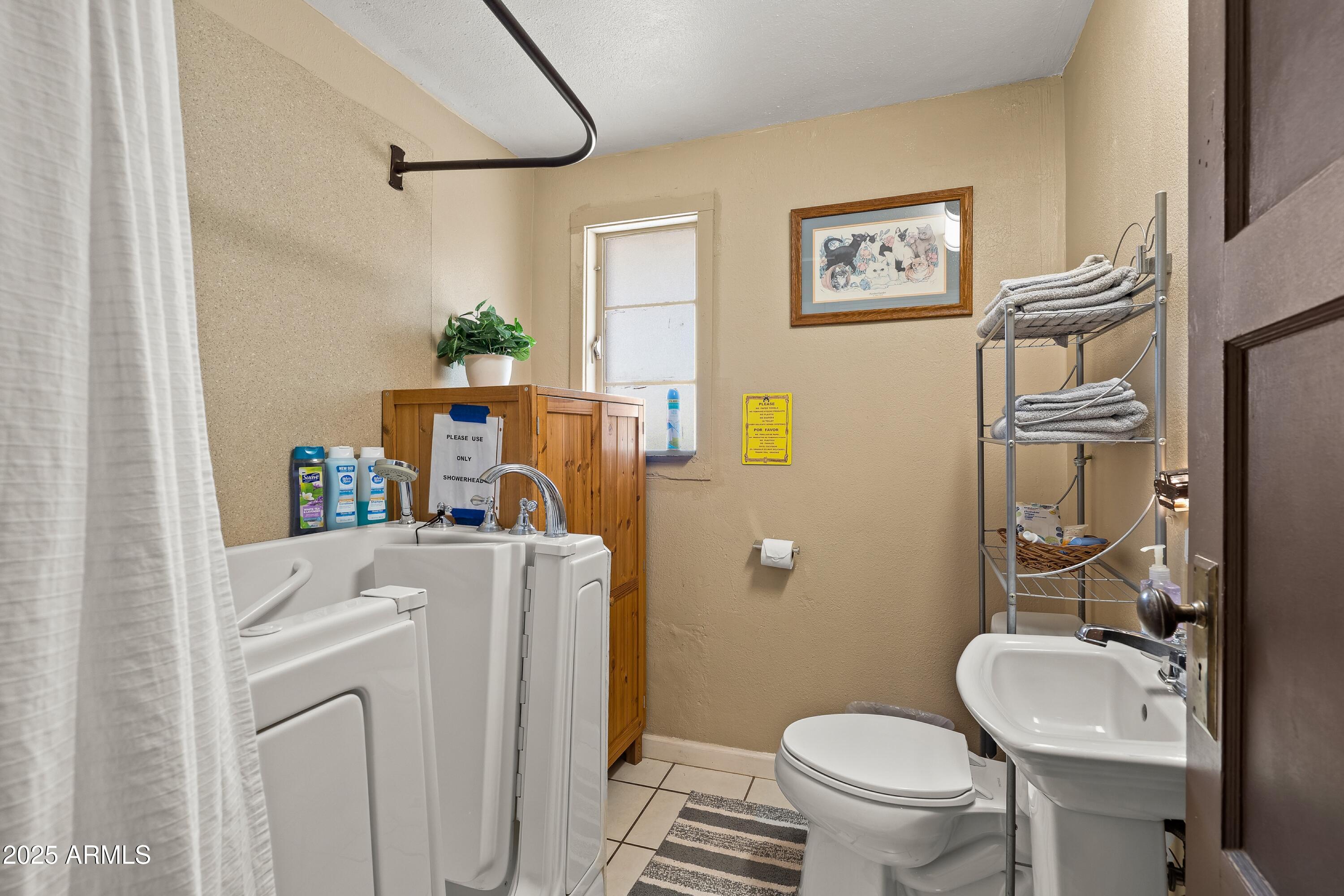 116 North 3rd Street Tombstone, AZ 85638 - Photo 15 of 64 a bathroom with a sink a toilet and a mirror