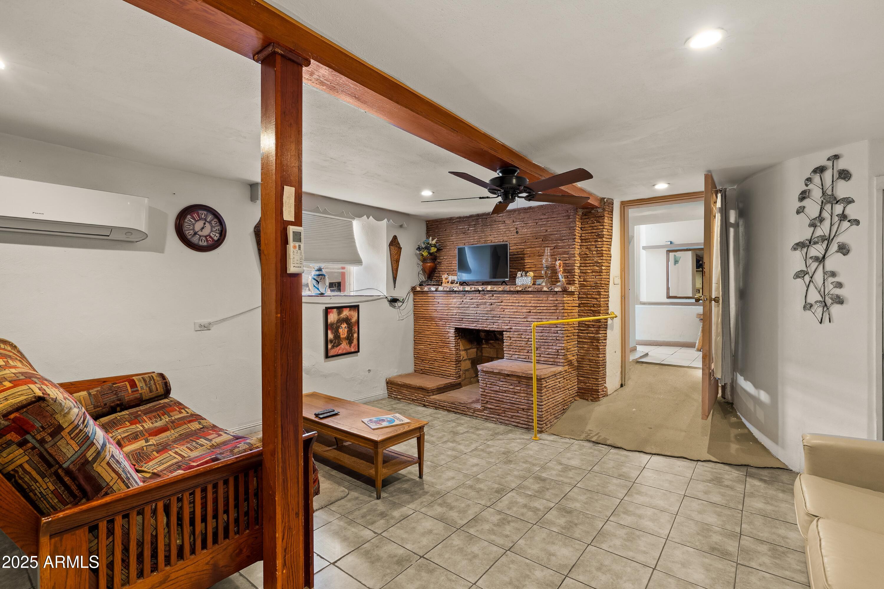 116 North 3rd Street Tombstone, AZ 85638 - Photo 21 of 64 a living room with furniture and a fireplace