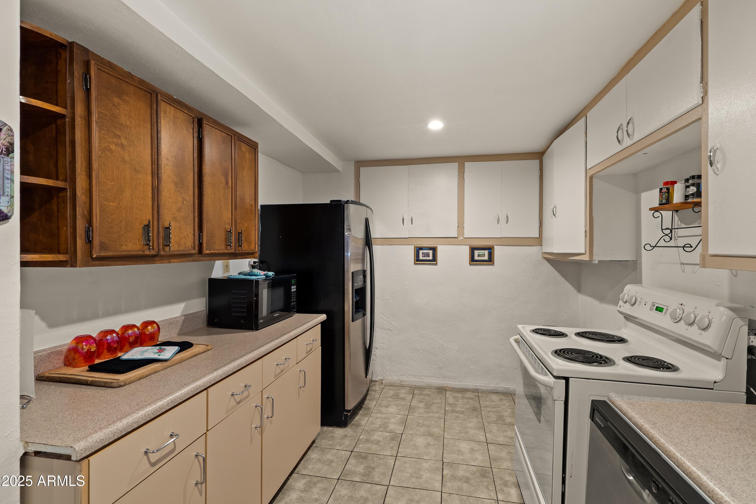 116 North 3rd Street Tombstone, AZ 85638 - Photo 26 of 64 a kitchen with a refrigerator sink and cabinets
