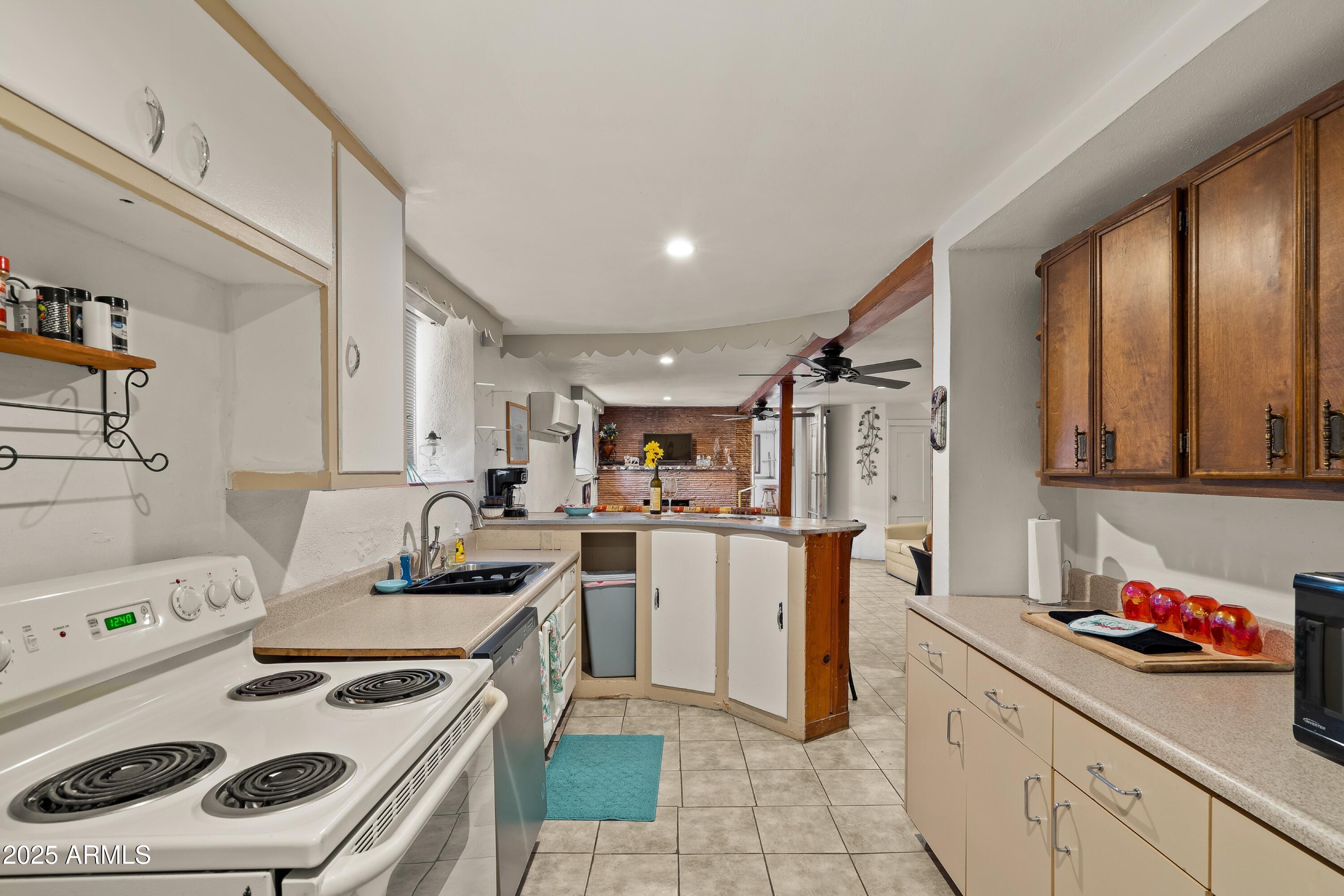 116 North 3rd Street Tombstone, AZ 85638 - Photo 27 of 64 a kitchen with a stove a sink and a refrigerator
