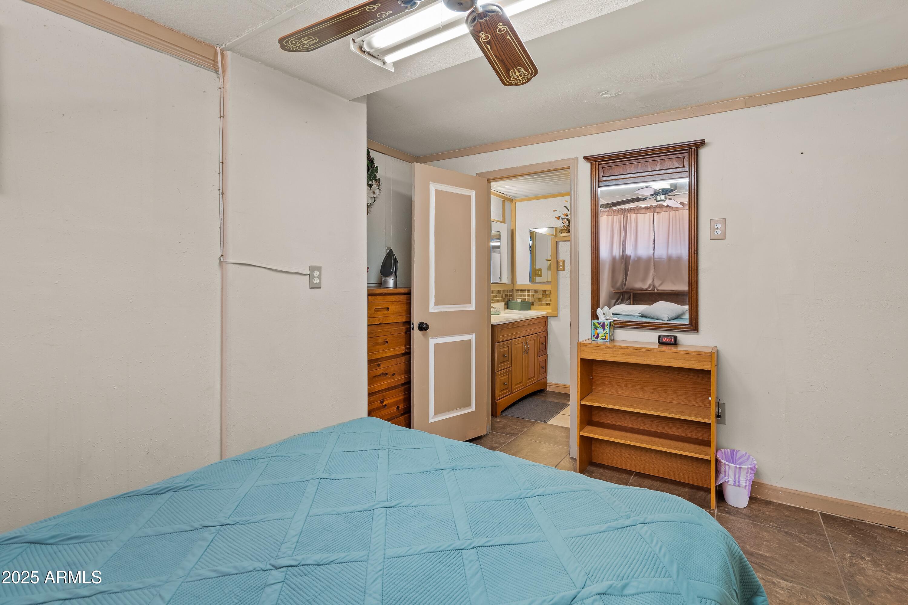 116 North 3rd Street Tombstone, AZ 85638 - Photo 29 of 64 a room with a bed and a view of kitchen