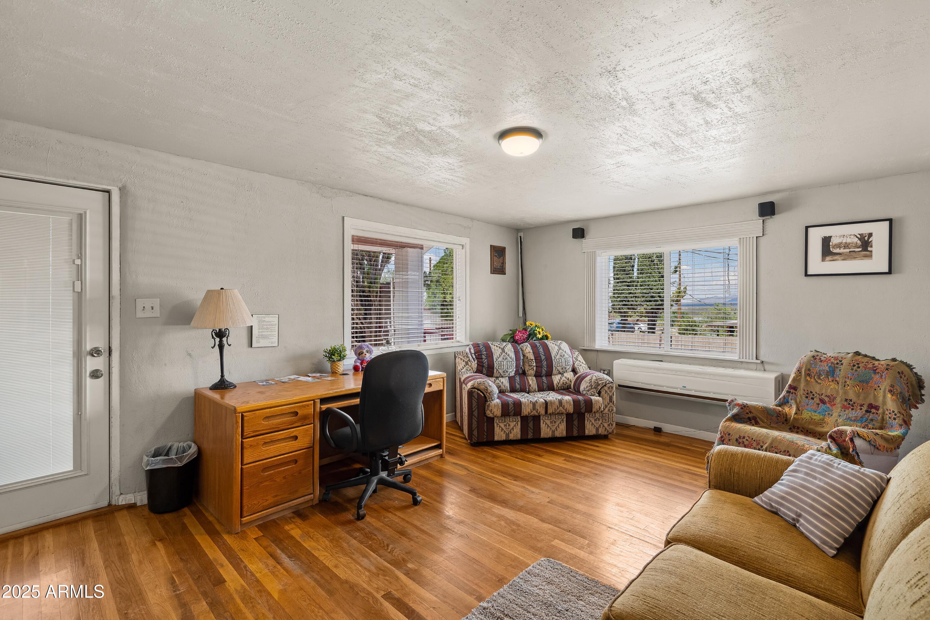 116 North 3rd Street Tombstone, AZ 85638 - Photo 6 of 64 a livingroom with workspace and a couch
