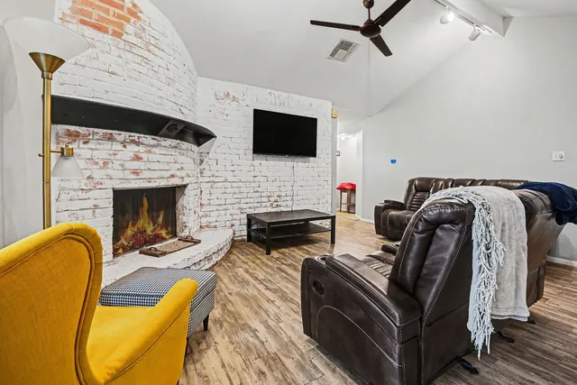 a living room with furniture fireplace and flat screen tv