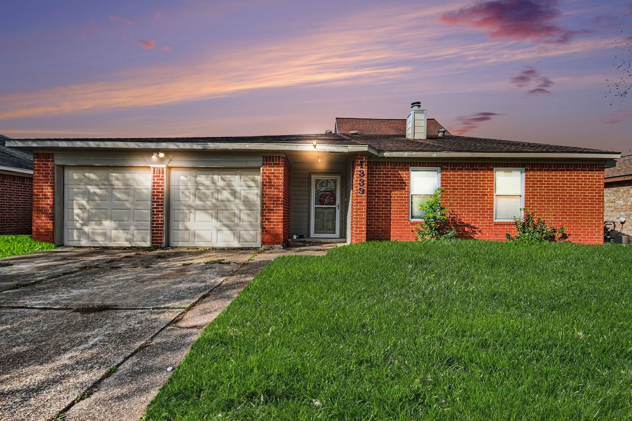 1339 Macclesby Lane Channelview, TX 77530 - Photo 4 of 21 a front view of a house with a yard and garage