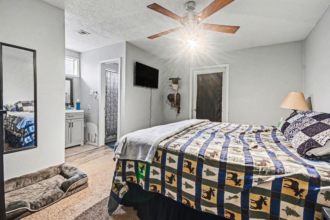 1339 Macclesby Lane Channelview, TX 77530 - Photo 7 of 20 a bedroom with a bed and a tv