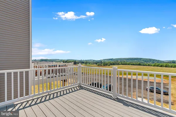 a view of city from a balcony with furniture