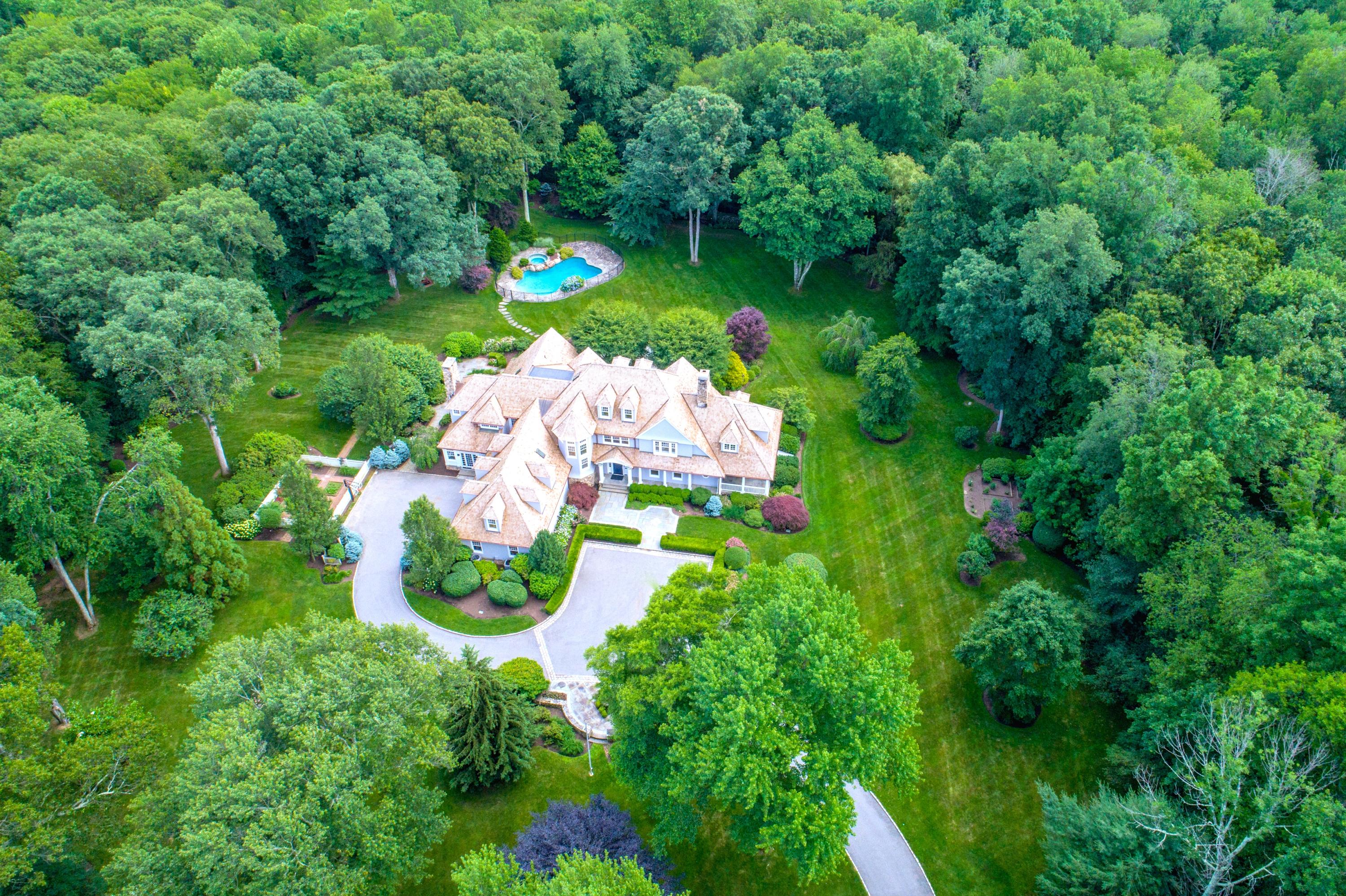 85 Lukes Wood Road New Canaan, CT 06840 - Photo 2 of 40 a backyard of a house with lots of green space and lake view