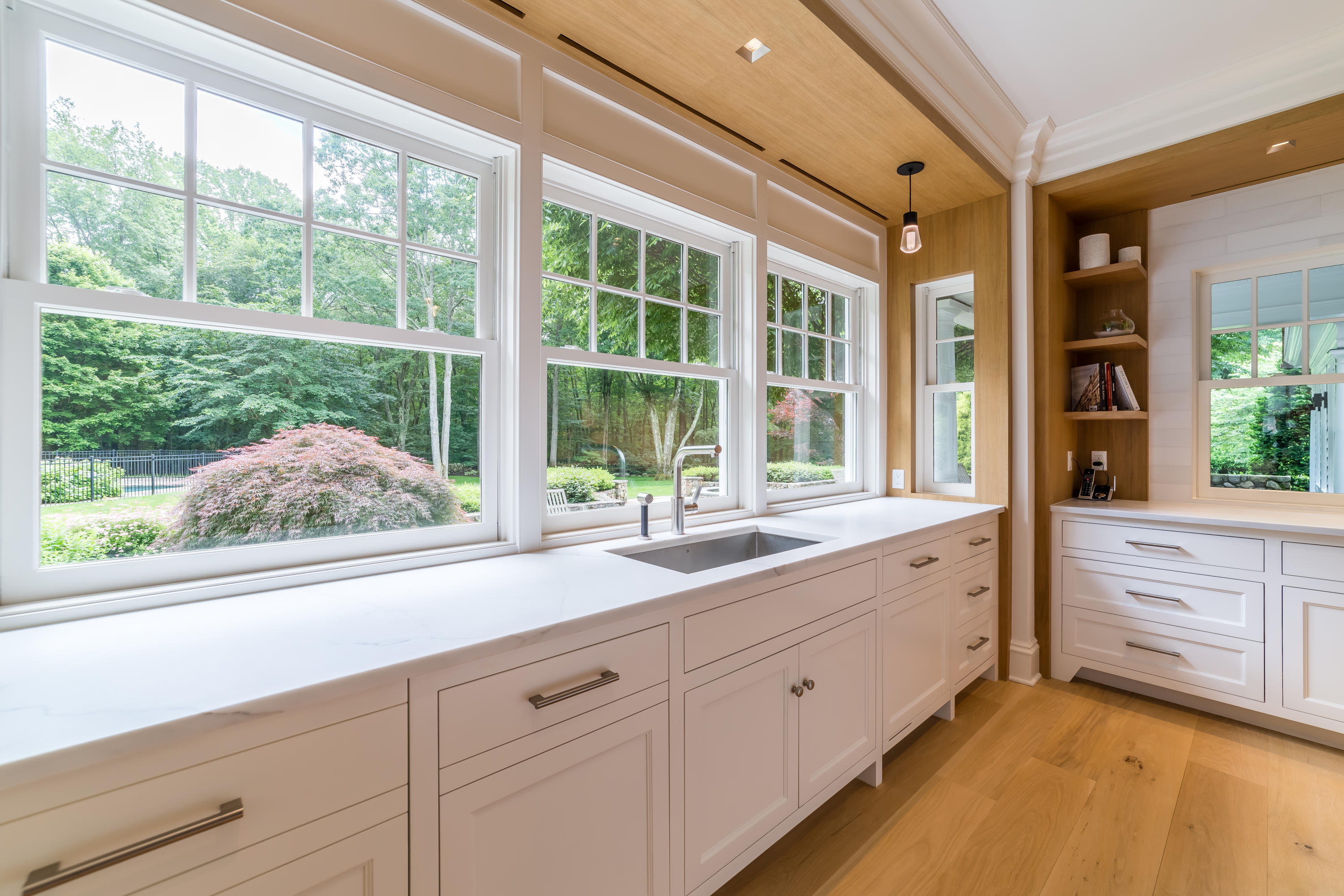 85 Lukes Wood Road New Canaan, CT 06840 - Photo 12 of 40 a kitchen with granite countertop white cabinets and a large window