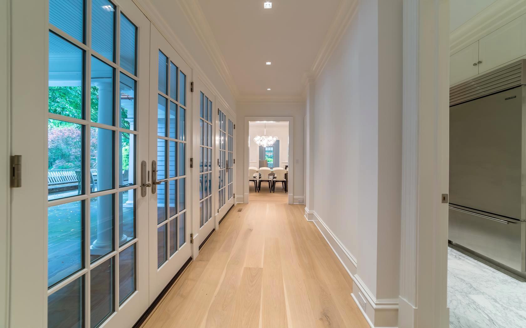 85 Lukes Wood Road New Canaan, CT 06840 - Photo 14 of 40 a view of a hallway with wooden floor and staircase
