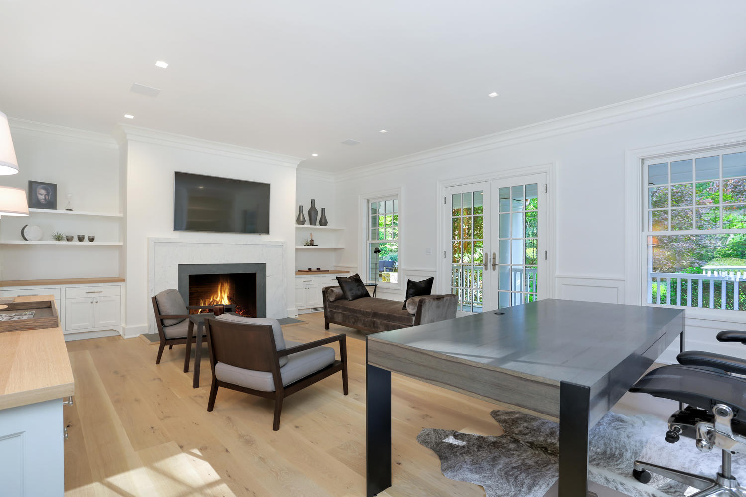 85 Lukes Wood Road New Canaan, CT 06840 - Photo 15 of 40 a living room with furniture a fireplace and a flat screen tv