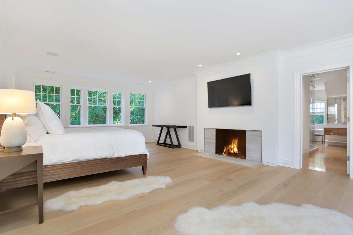 85 Lukes Wood Road New Canaan, CT 06840 - Photo 19 of 40 a bed room with furniture and a fireplace