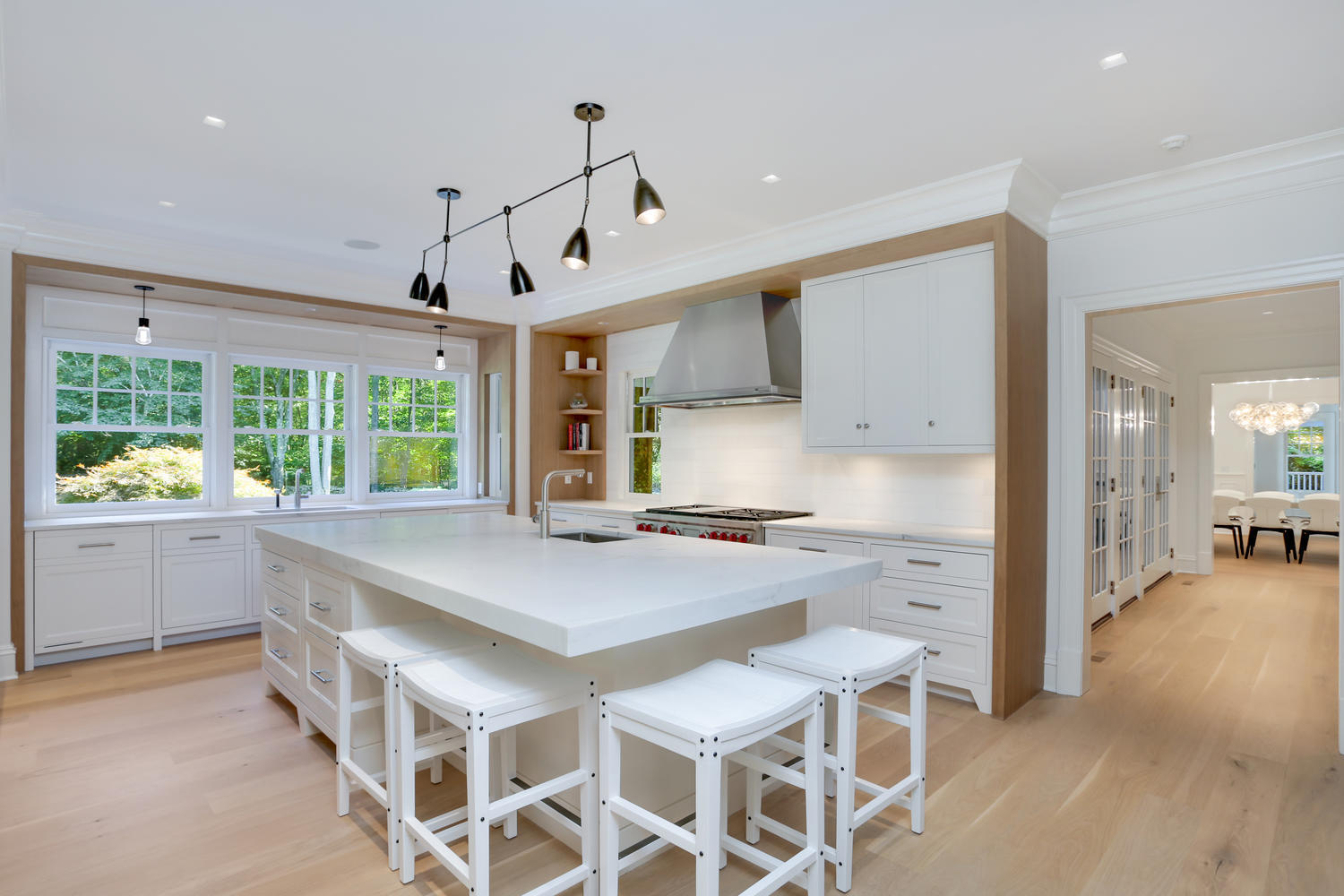 85 Lukes Wood Road New Canaan, CT 06840 - Photo 10 of 40 a kitchen with stainless steel appliances a table and chairs in it