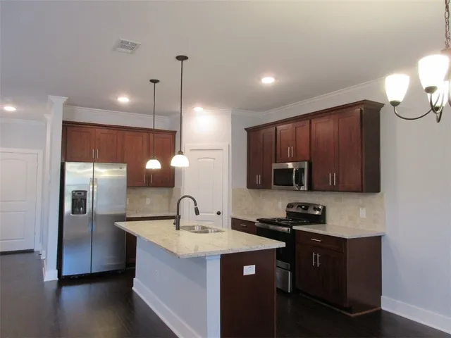 a kitchen with a sink and cabinets