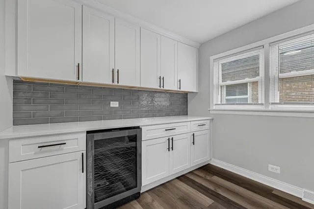 a kitchen with granite countertop white cabinets and white appliances