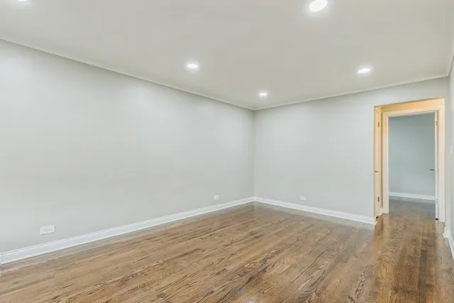 a view of wooden floor and windows in a room