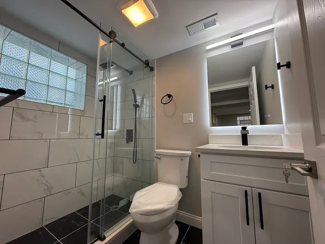 a bathroom with a toilet sink and shower