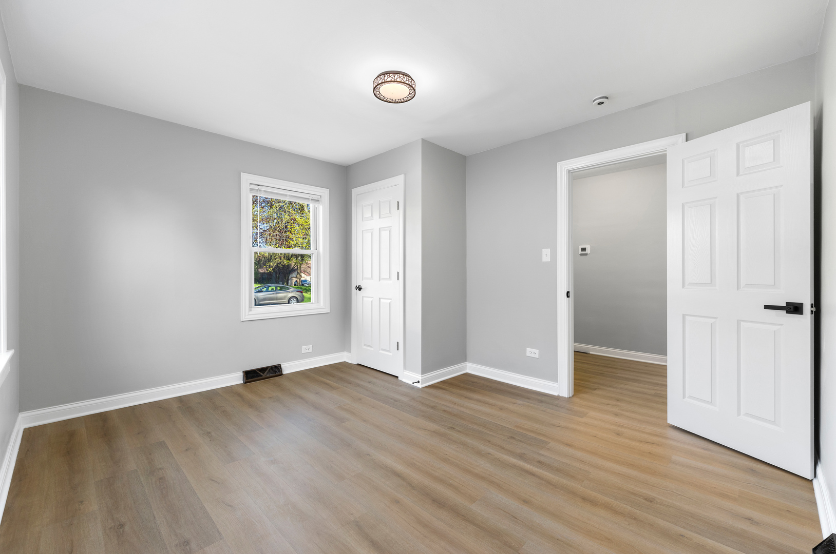 22 North 12th Street St. Charles, IL 60174 - Photo 17 of 37 an empty room with wooden floor and windows