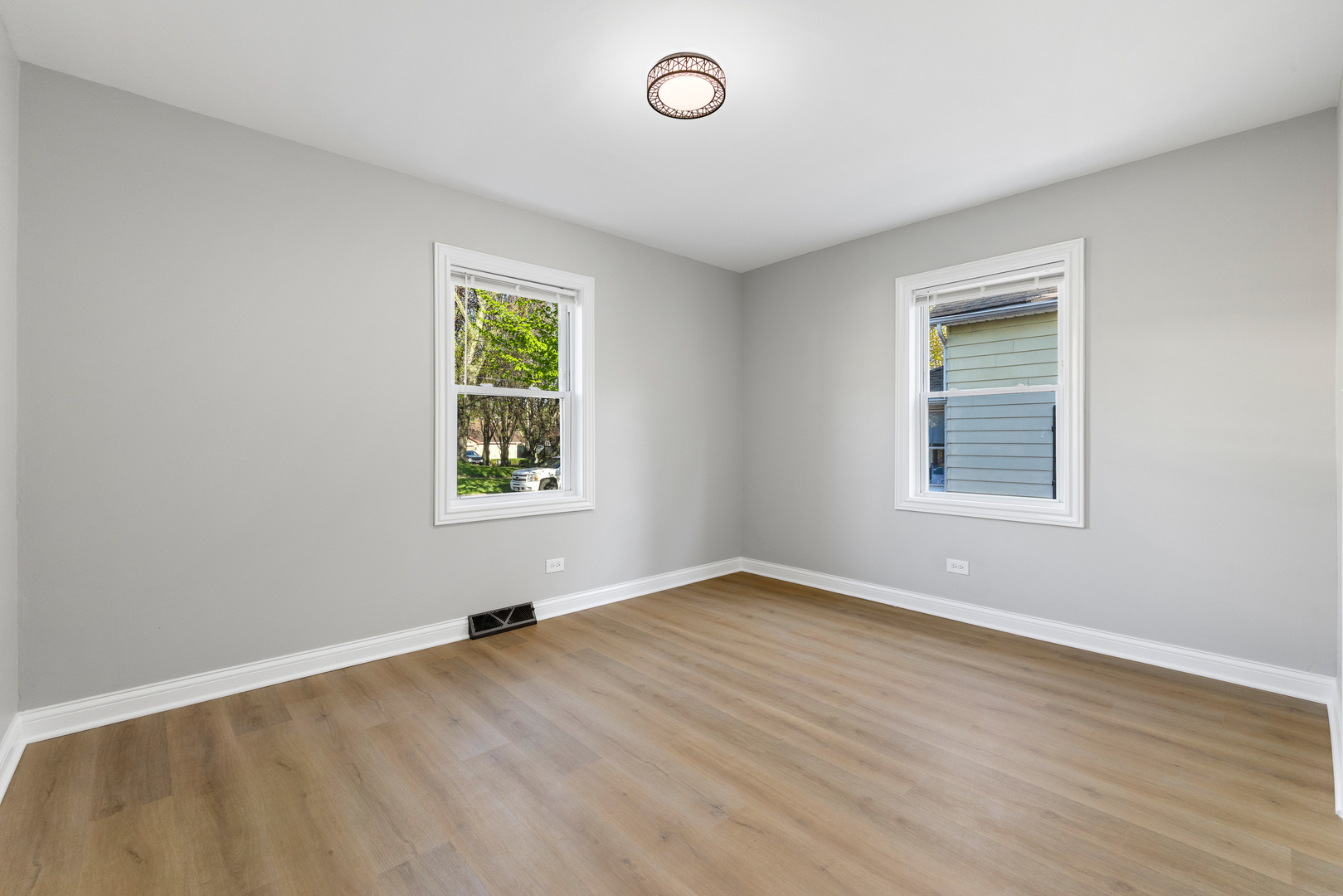 22 North 12th Street St. Charles, IL 60174 - Photo 21 of 37 a view of an empty room with a window and wooden floor