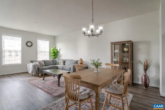 a view of a dining room with furniture wooden floor and chandelier