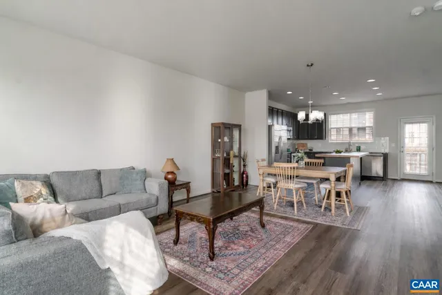 a living room with furniture and kitchen view