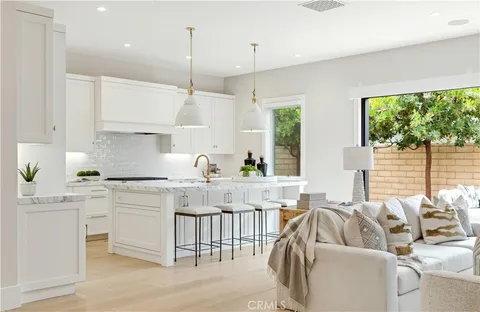 a kitchen with stainless steel appliances granite countertop a sink a stove and a refrigerator