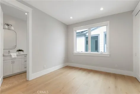 an empty room with a bathroom and a sink