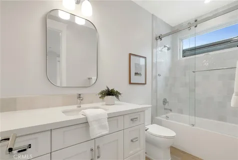 a bathroom with a sink mirror toilet and bathtub