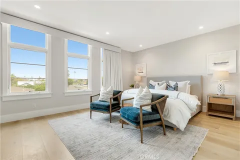 a bed room with a bed and a chair