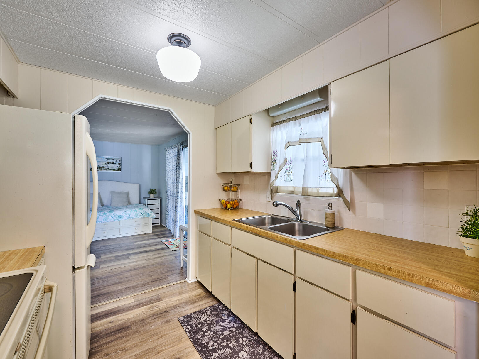 6977 Southeast Delegate Street Hobe Sound, FL 33455 - Photo 18 of 60 a kitchen with a sink and cabinets