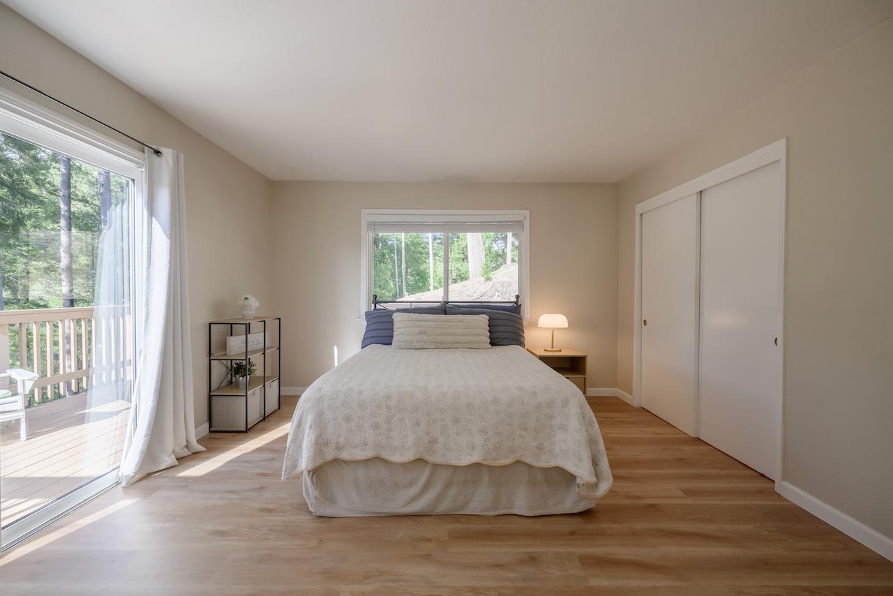 155 Rabbits Run Road Santa Cruz, CA 95060 - Photo 66 of 113 a spacious bedroom with a bed and wooden floor
