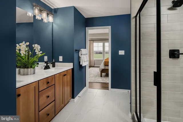 a spacious bathroom with a double vanity sink and a mirror