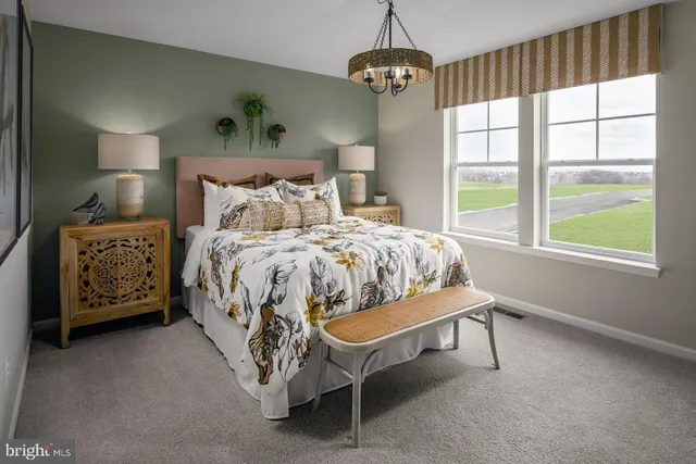 a bed sitting in a bedroom next to a window