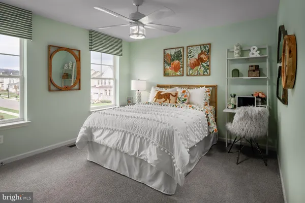 a spacious bedroom with a bed couch and a window