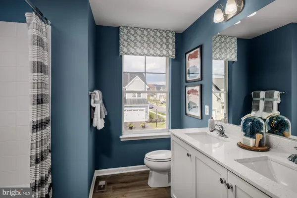 a bathroom with a toilet a sink and a window