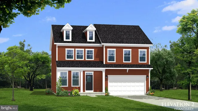 front view of a brick house with a yard