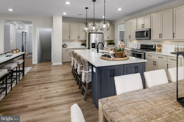 a kitchen with counter space dining table and stainless steel appliances