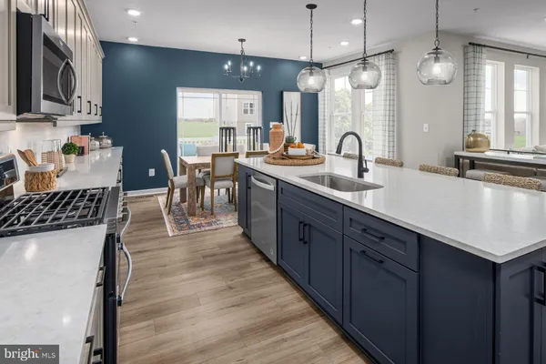 a large kitchen with lots of counter space and sink
