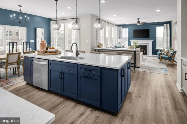 a large kitchen with stainless steel appliances a large center island and wooden floor