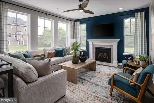 a living room with furniture a fireplace and a flat screen tv