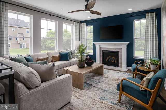 a living room with furniture a fireplace and a flat screen tv