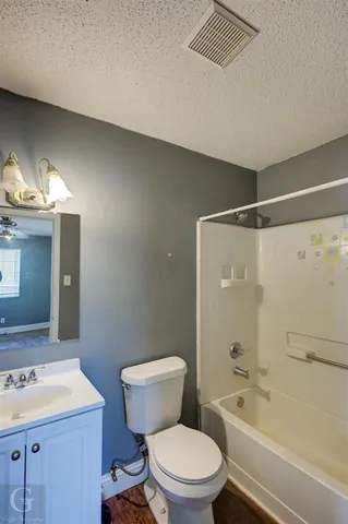 a bathroom with a sink a toilet a mirror and shower