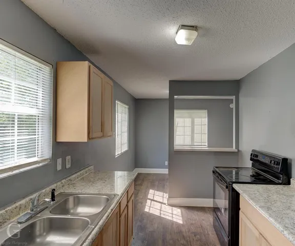 a kitchen that has a sink and a stove in it