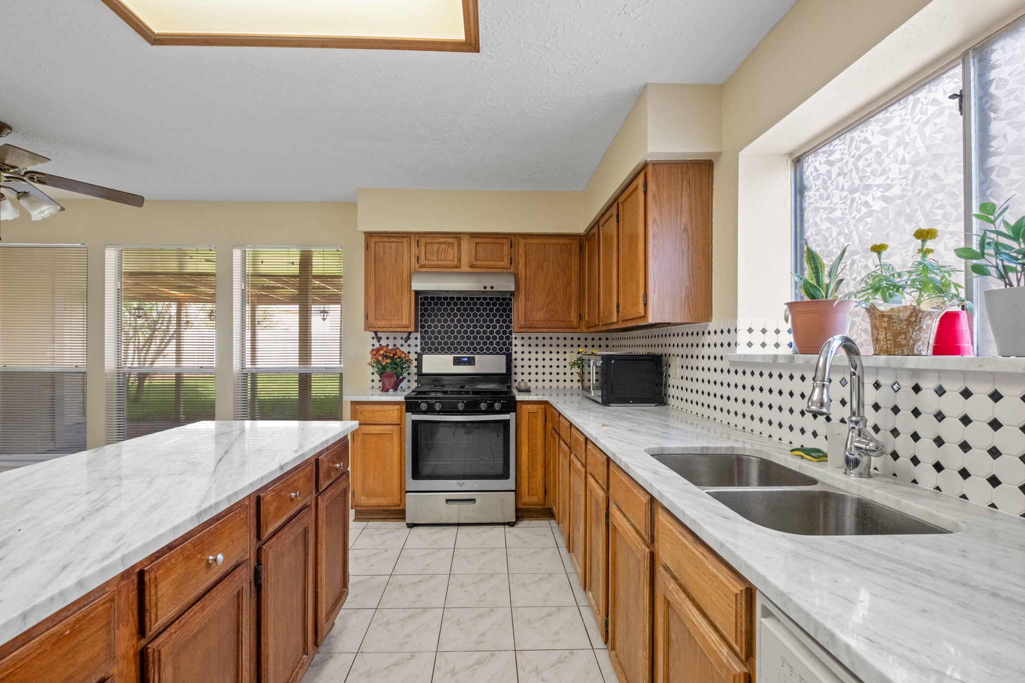 4131 Club Valley Drive Houston, TX 77082 - Photo 13 of 28 a kitchen with stainless steel appliances granite countertop a sink stove and refrigerator