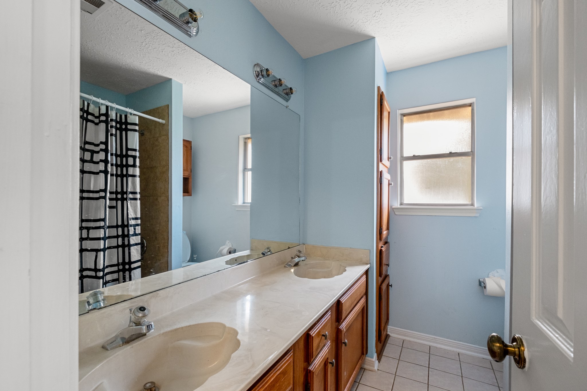 4131 Club Valley Drive Houston, TX 77082 - Photo 18 of 28 a bathroom with a sink and a mirror