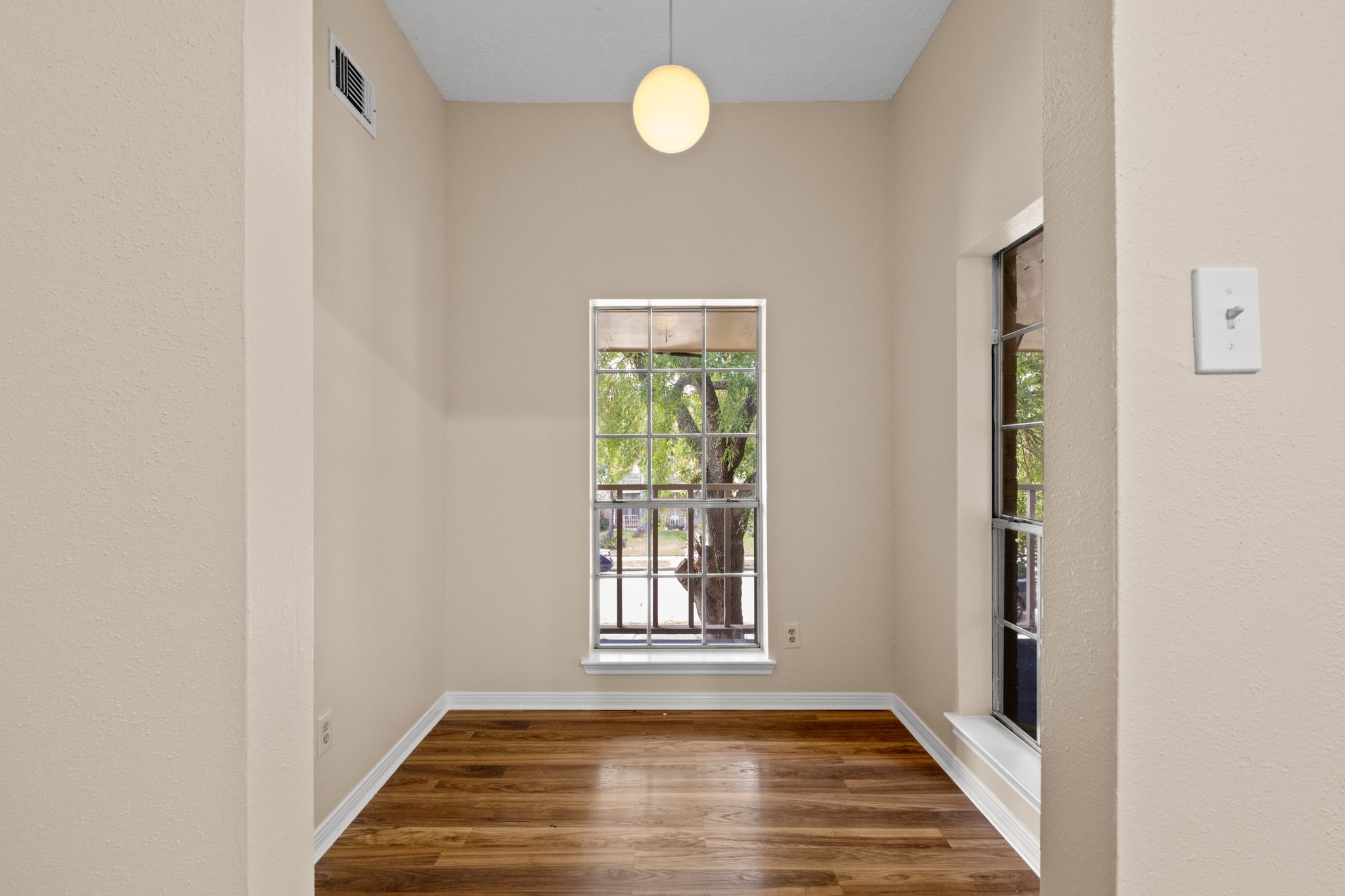 4131 Club Valley Drive Houston, TX 77082 - Photo 21 of 28 a view of an empty room with window and wooden floor