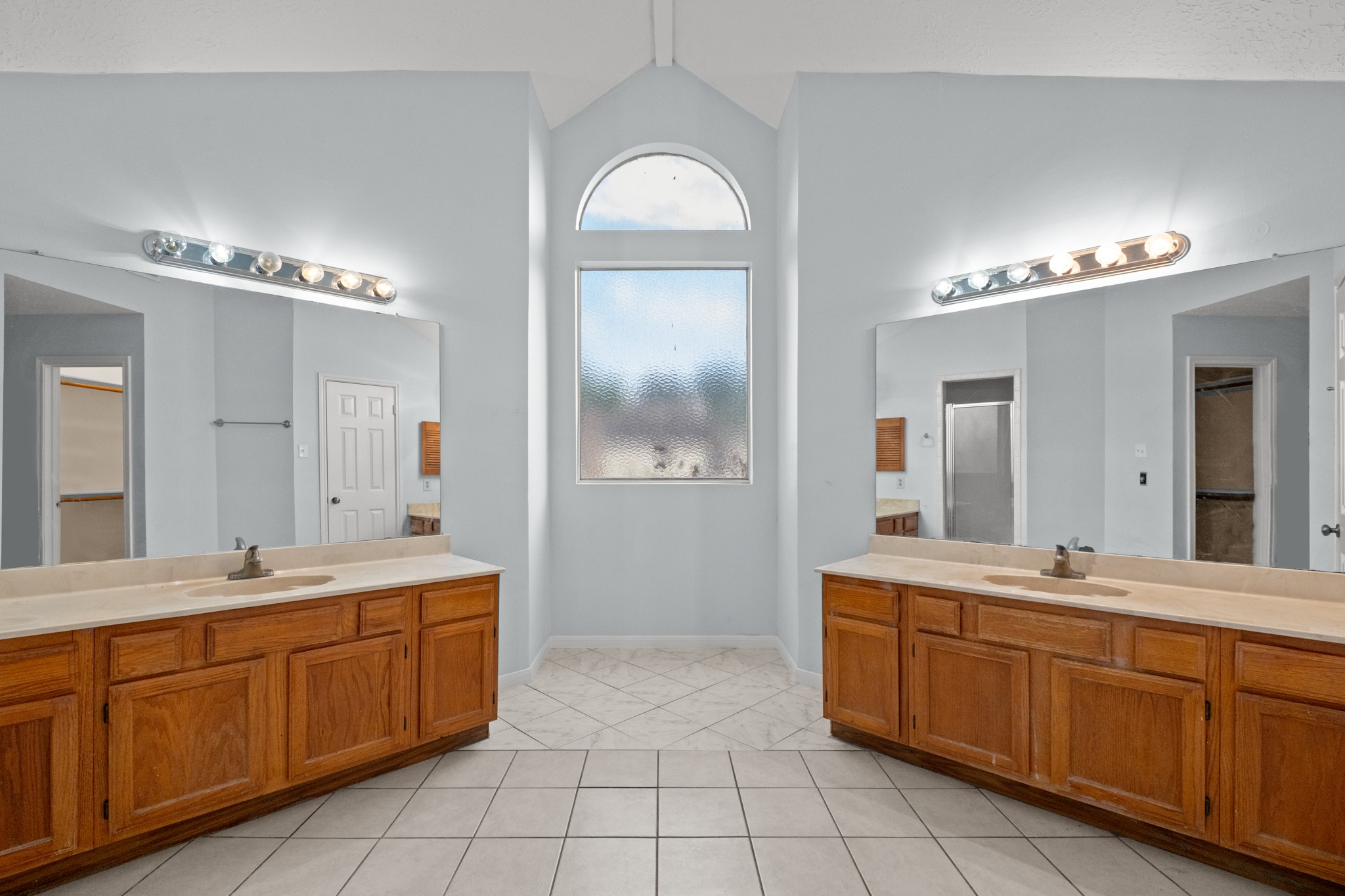4131 Club Valley Drive Houston, TX 77082 - Photo 22 of 28 a bathroom with a double vanity sink and a mirror