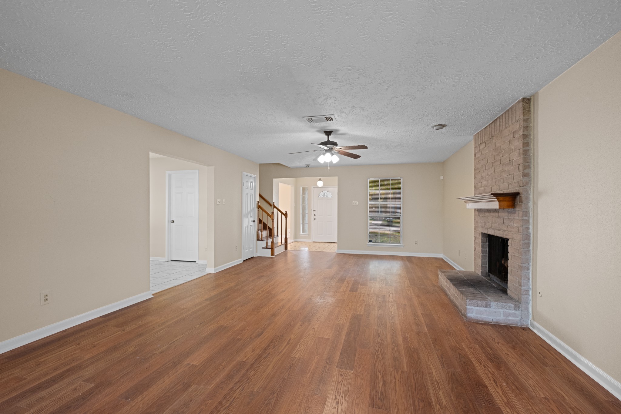 4131 Club Valley Drive Houston, TX 77082 - Photo 8 of 28 a view of an empty room with wooden floor and a fireplace